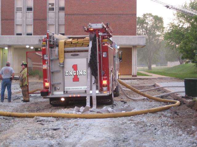 Firefighters Steve Gray and Larry Groseclose conversing during a drill.